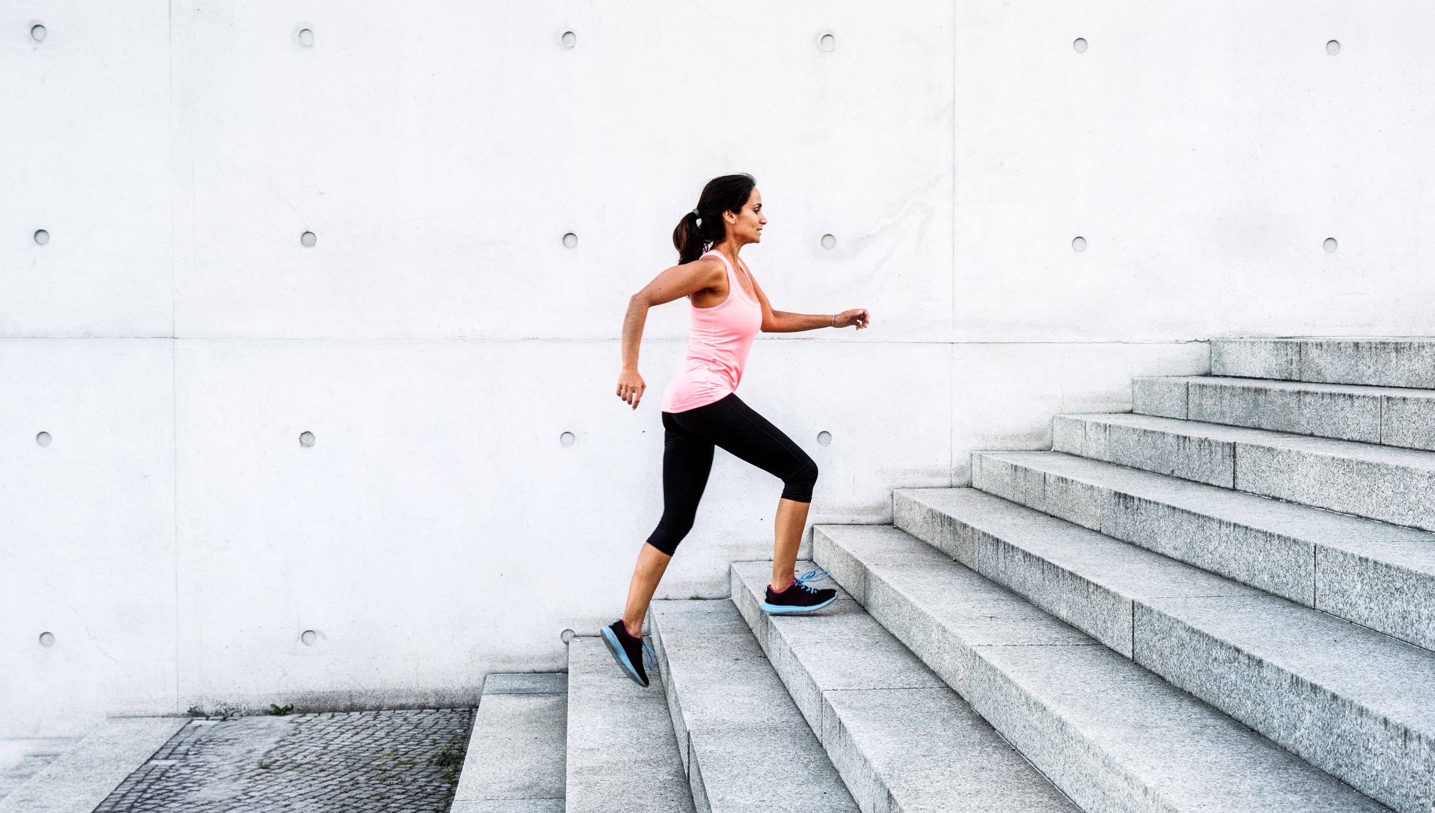 Person walking up stairs for exercise.